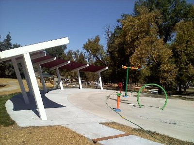 Image of shade structures set in a semi circle for water play area.