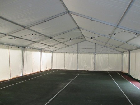 Image of clear span structure on 10 ft legs over tennis court