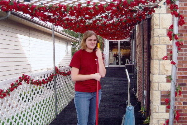 Image of enty way with rose garlands for party tent rental Lincoln, NE 