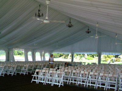 Image of chairs set inside tent for wedding ceremony