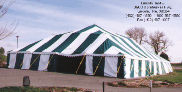 Image of green and white tent set for an outdoor party