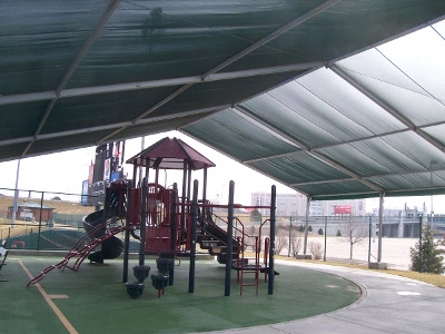 Image of inside shade structure over large playground slide.
