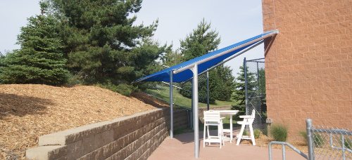 Image of a triangular shade cover for ticket takers at pool. 