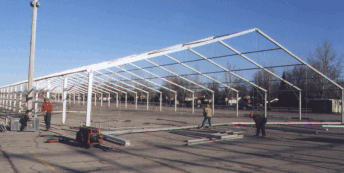 image of clear span tent frame work being assembled