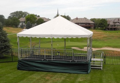 Image of tent set on decking to give raised view of golf course