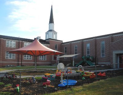 Image of an umbrella style playground shade cover at church daycare.