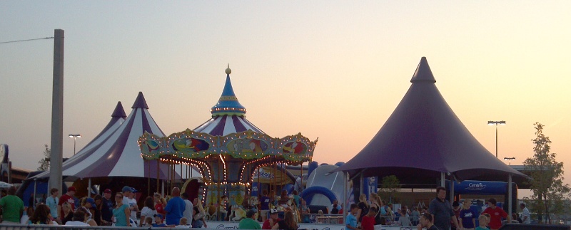 Image of double peak shade structure with nearby merry go round top and single peak shade structure.