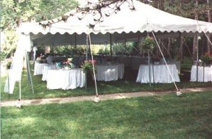 Image of an elegant but simply decorated tent set up for a large reception 